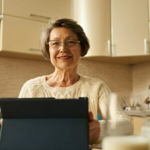 Old female surf the internet, making online purchases