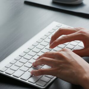Woman type on keyboard at home